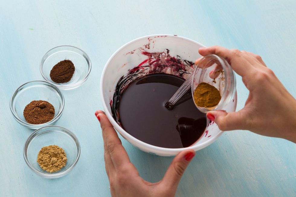 mixing all the ingredients together for a spiced wax