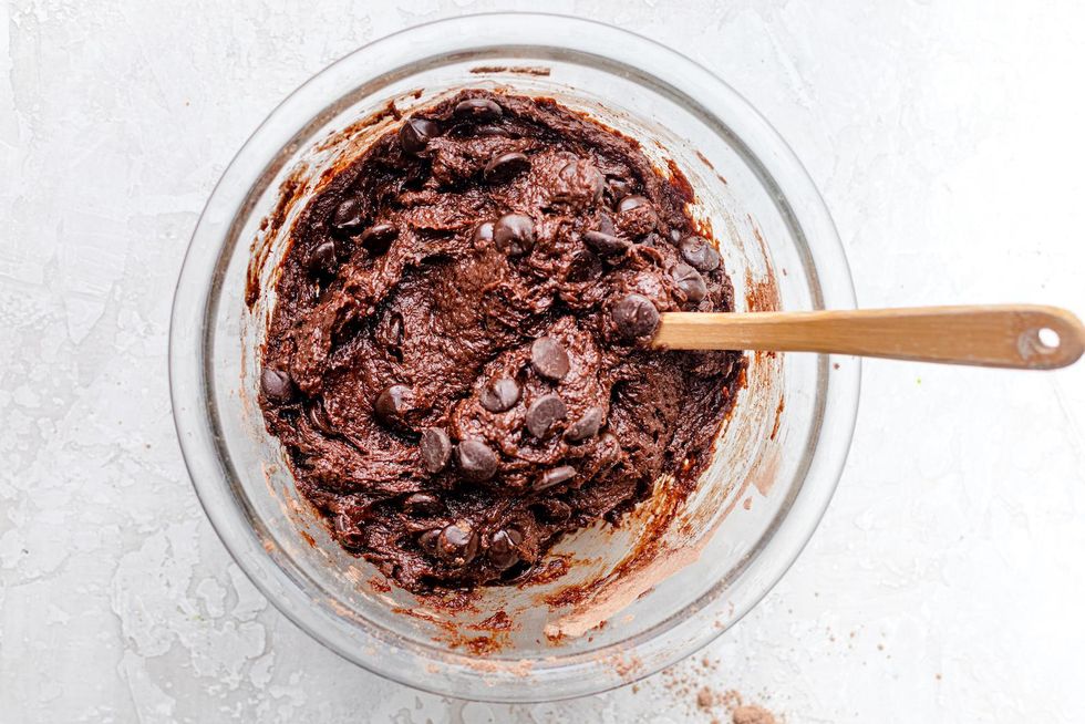 mixing chocolate chips into the brownie batter