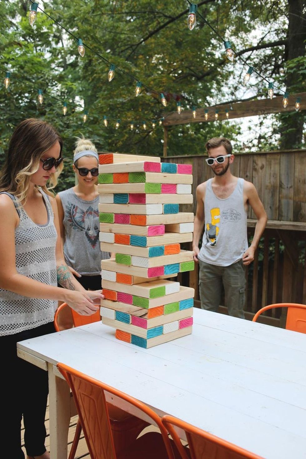 people playing giant jenga together outdoors love language