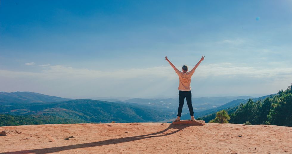 person at edge of cliff