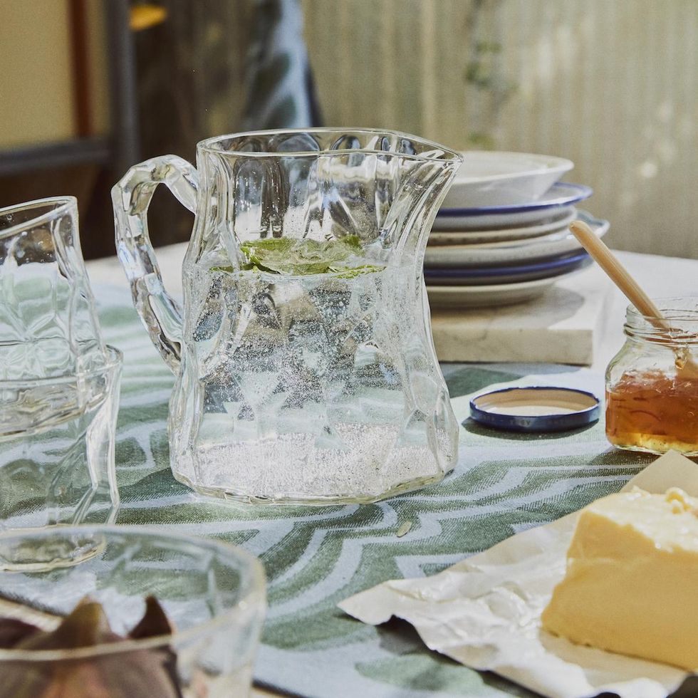 pitcher and glass with food on a table