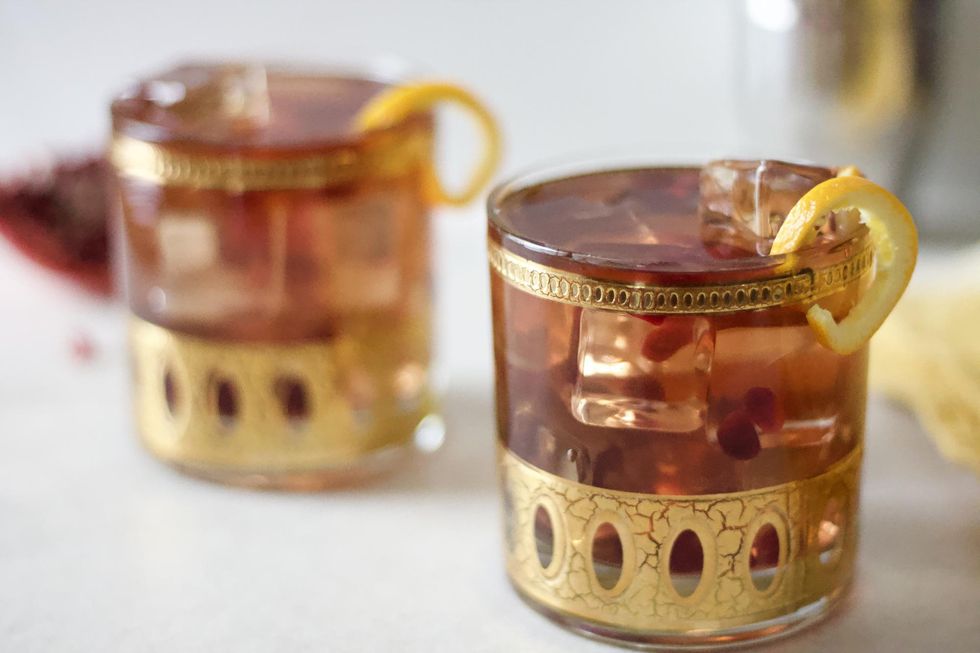 pomegranate ginger beer cocktail in gold cocktail glass