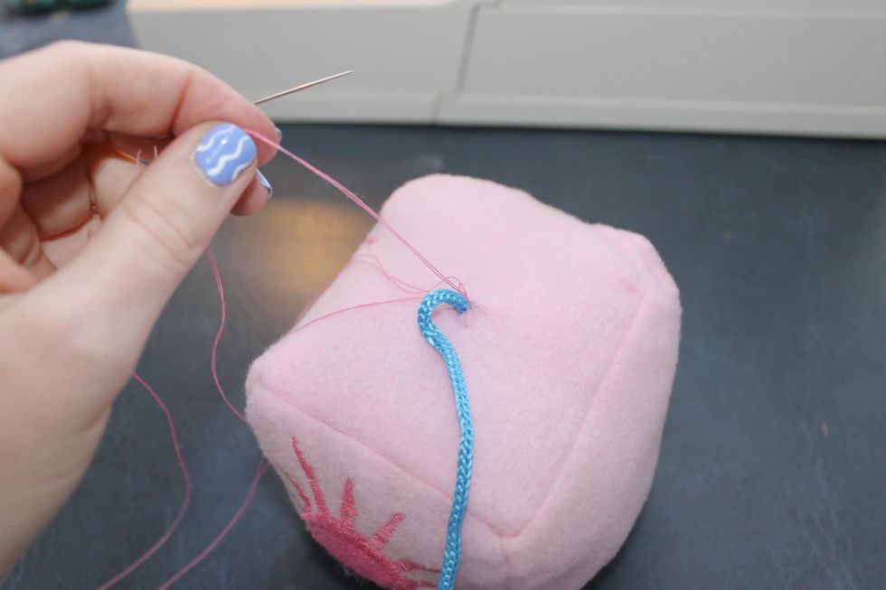 sewing the cord into the top of the cube