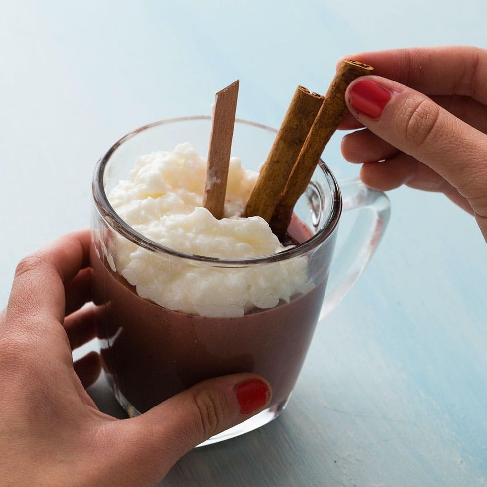 sticking cinnamon sticks into the Chai Tea candle