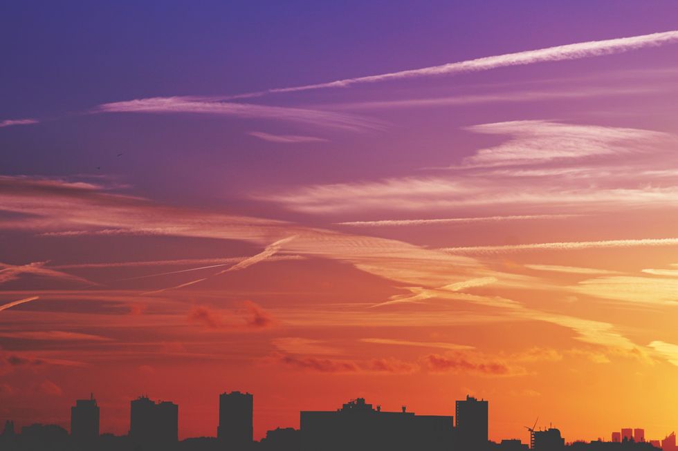 sunset behind city skyline