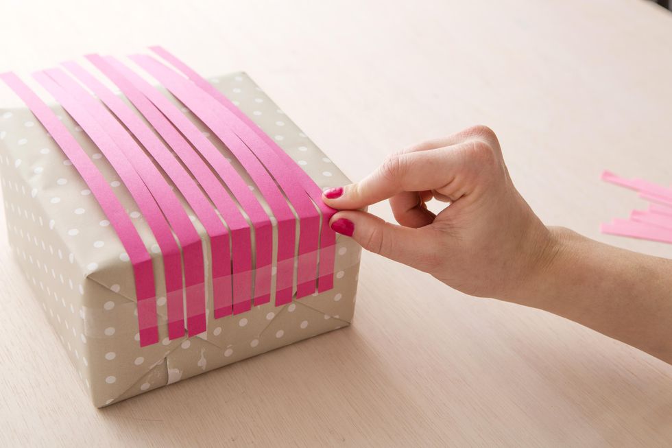 taping pink paper strips