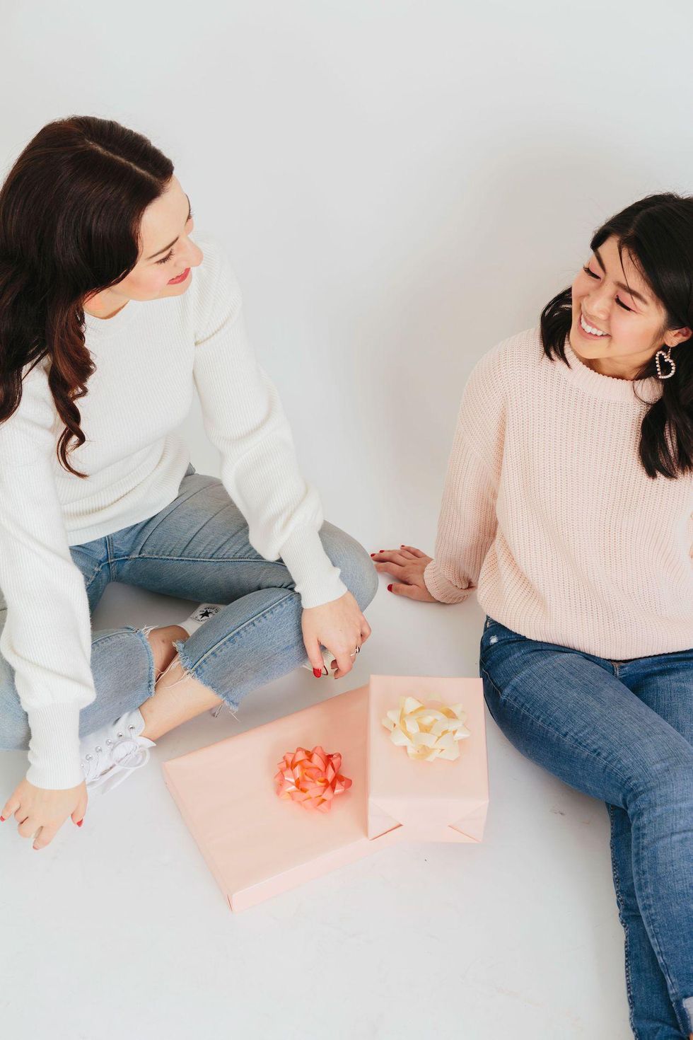 two friends exchanging gifts on Random Acts of Kindness day