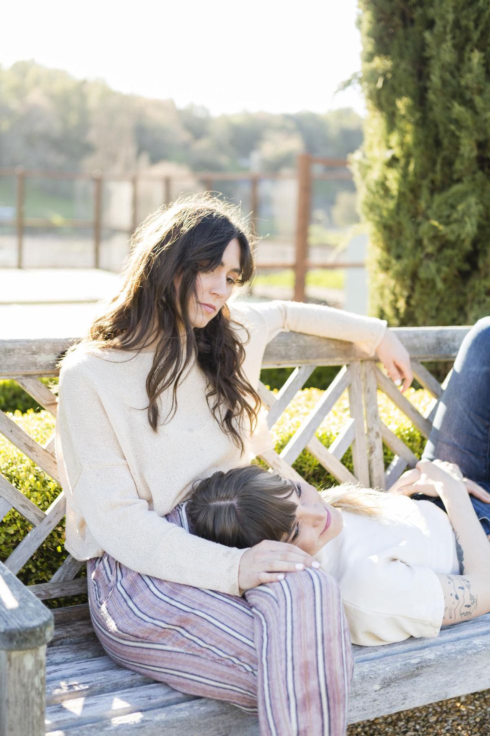 two friends sitting on a bench together