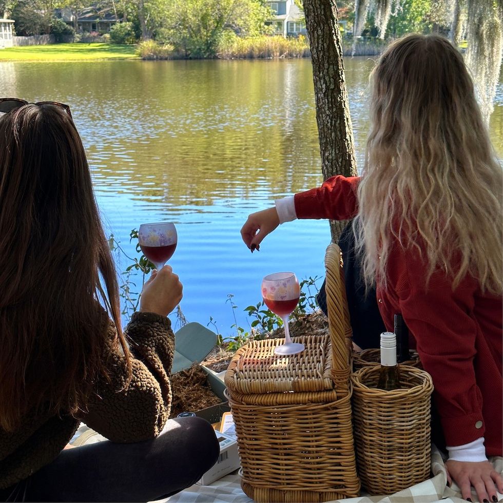 two girls having a picnic by the water