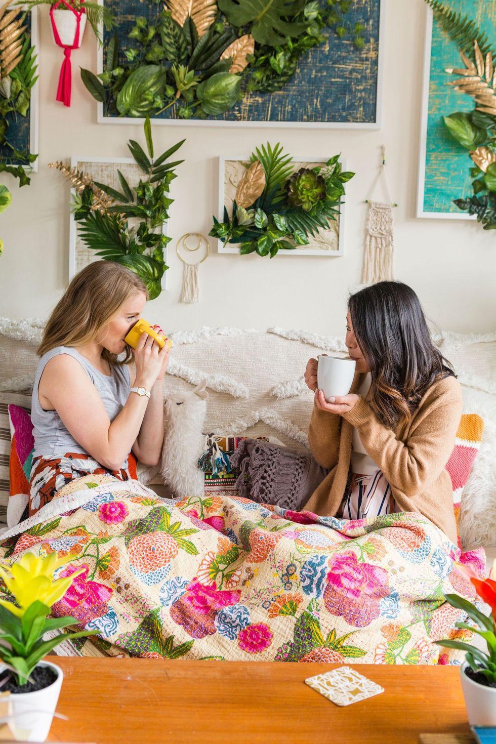 two girls on the couch drinking tea