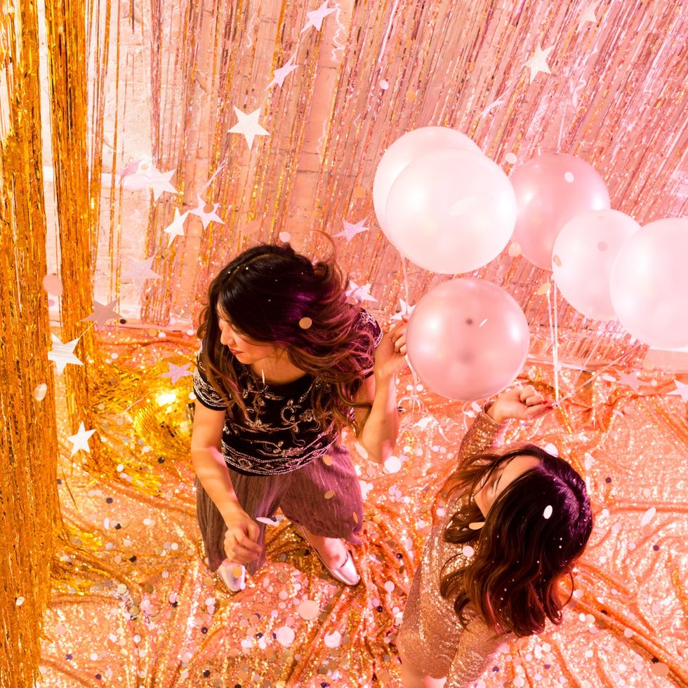 two people dancing in a sparkly room