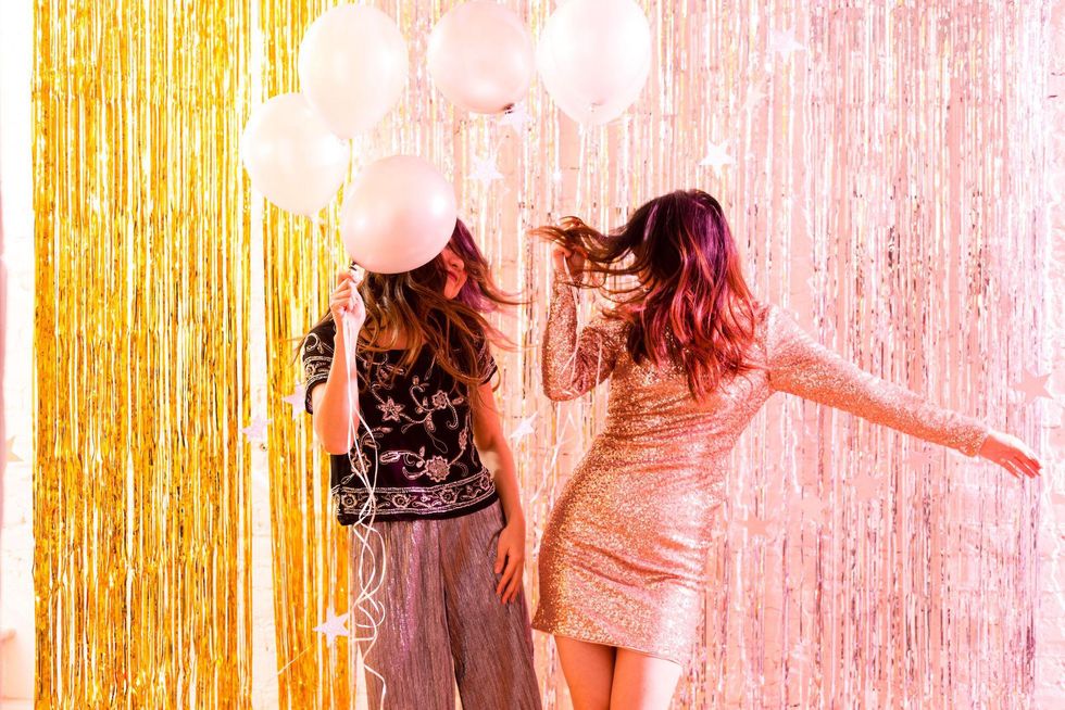 two women dancing with balloons