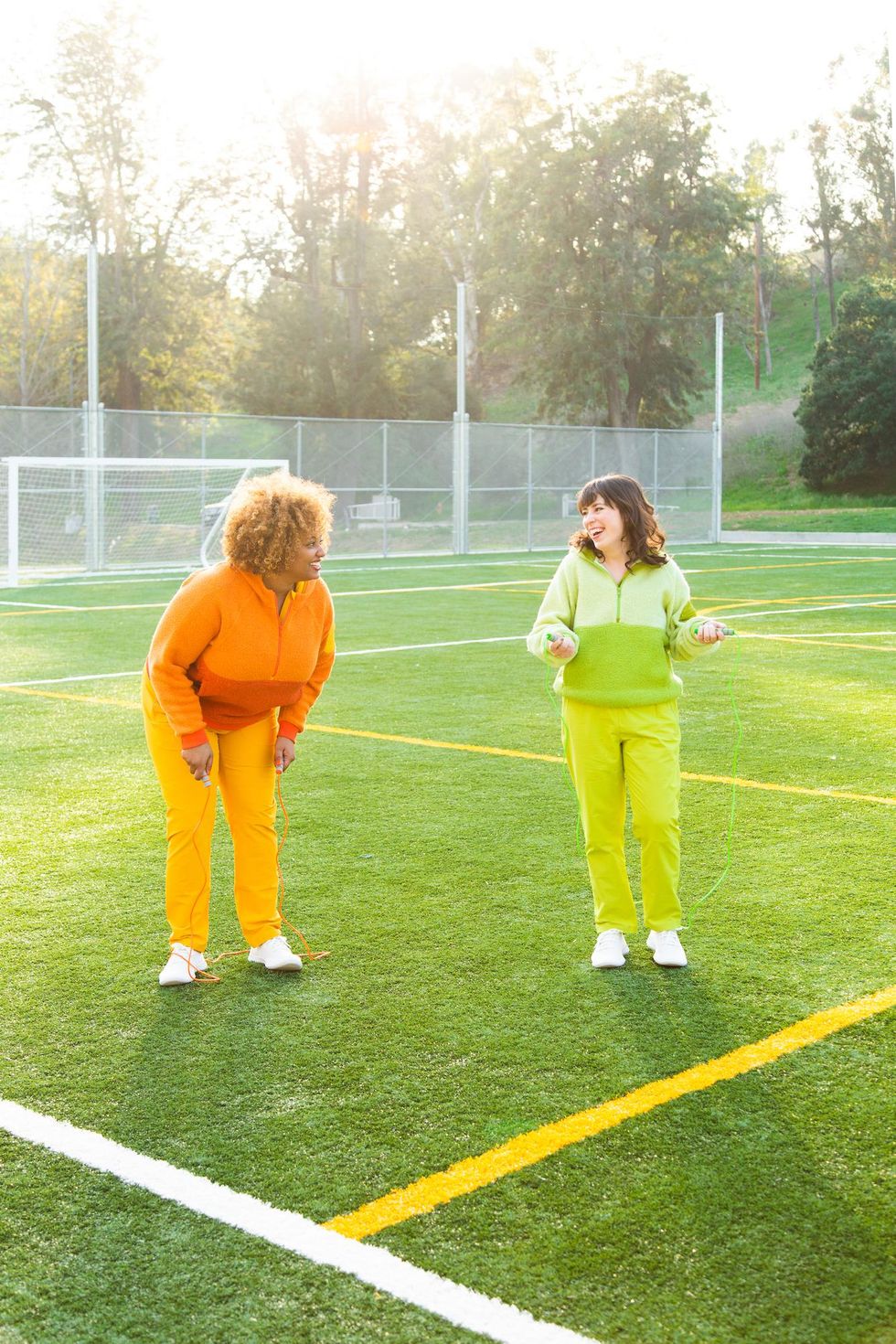 two women jumping rope and having fun while working out