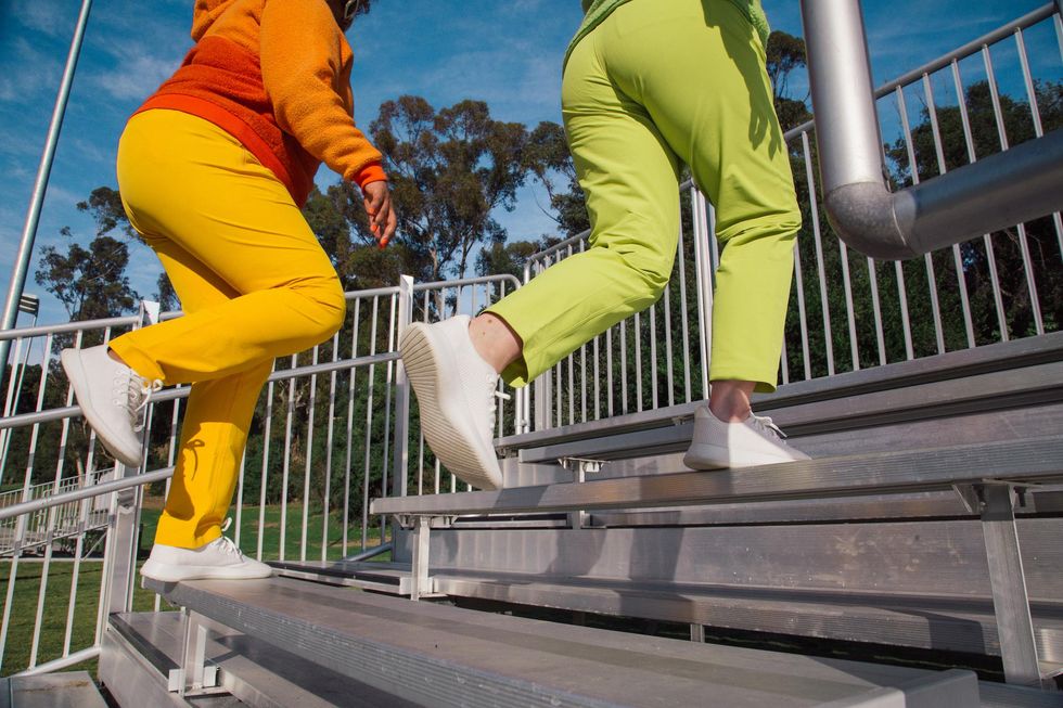 two women running up stadium steps for exercise the big climb