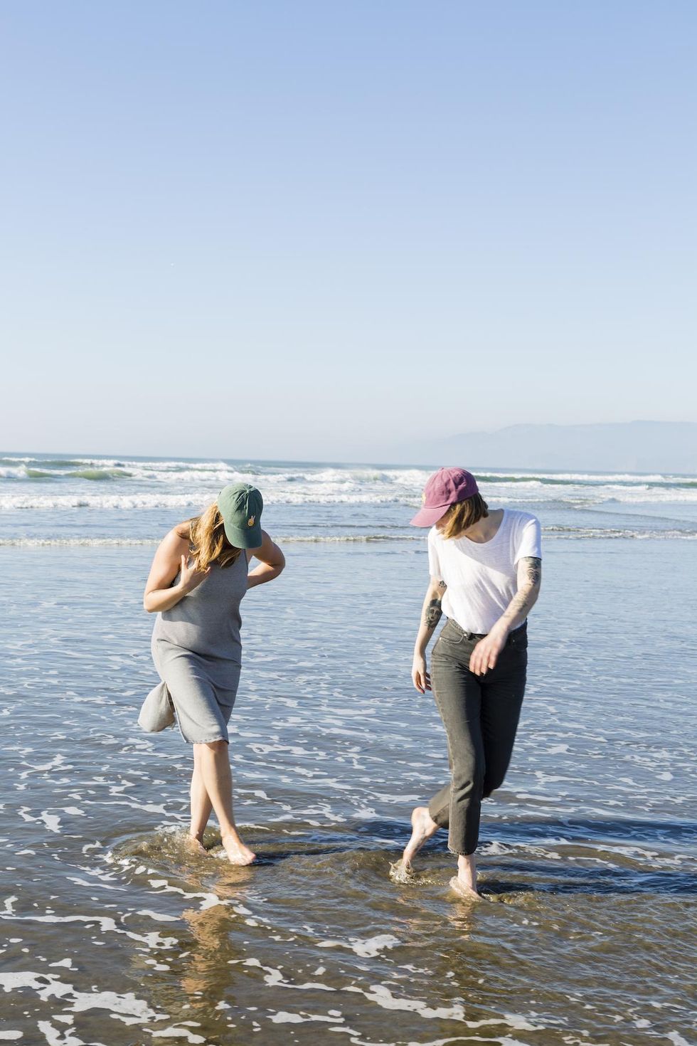 two women walking on a beach together