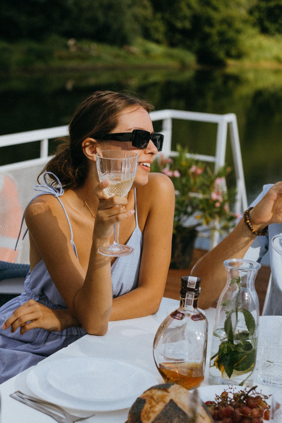 woman at a table drinking wine