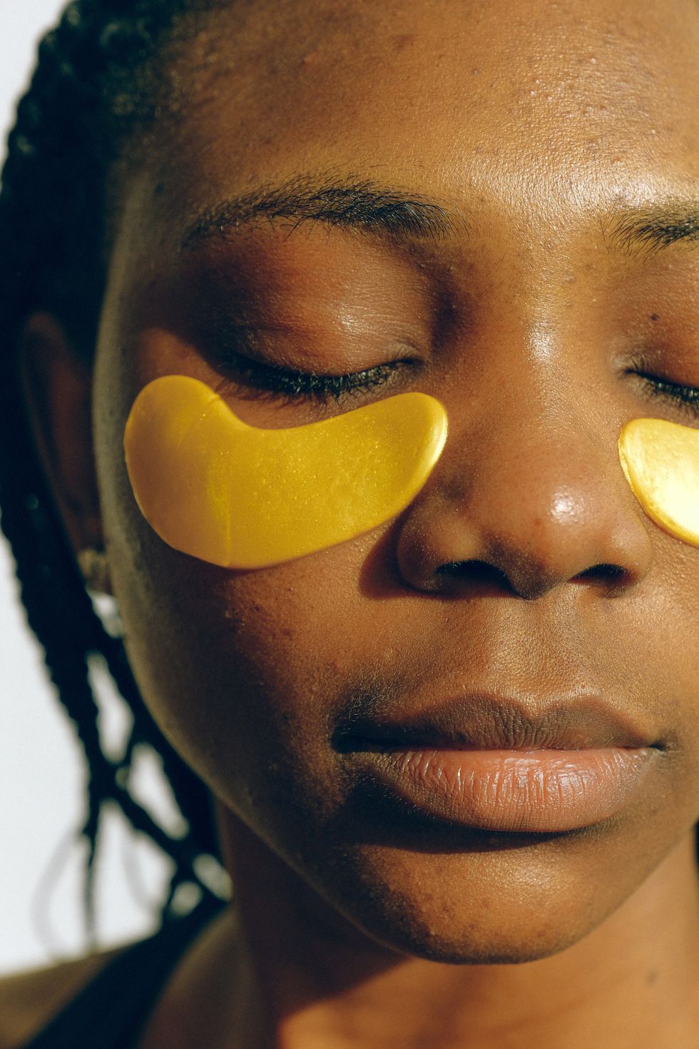 woman doing self care with eye patches