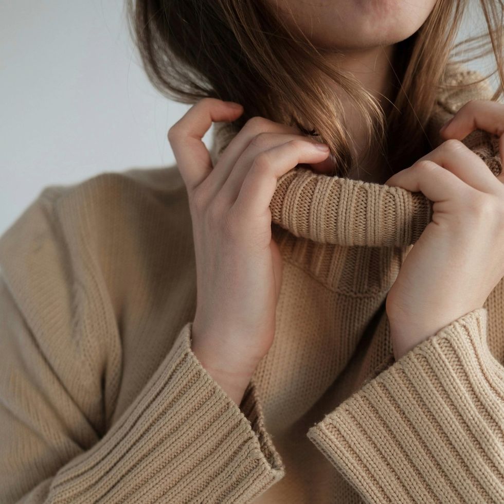 woman folding her sweater collar