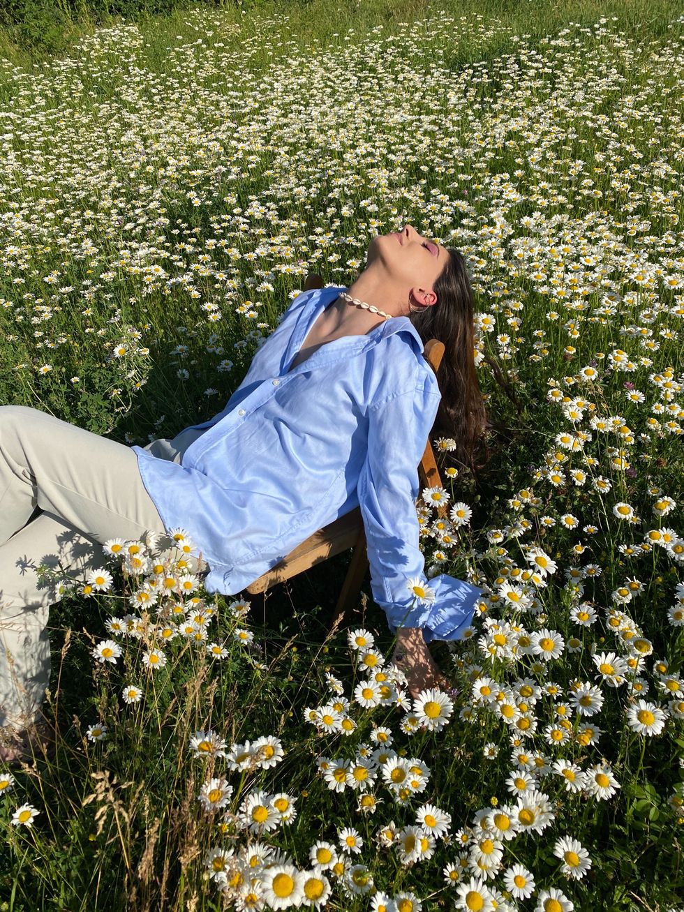 woman in a flower field at peace