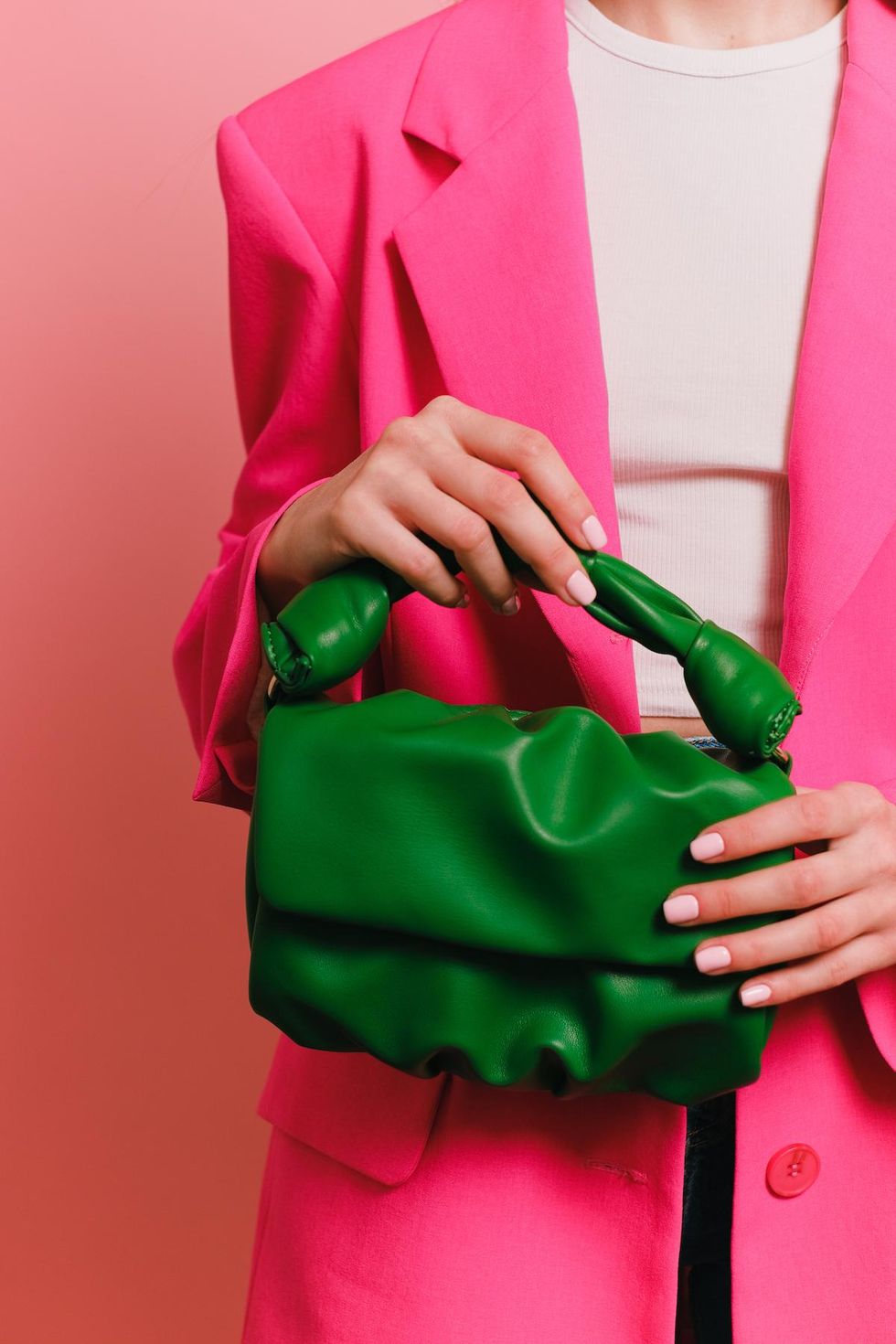 woman in pink blazer holding green purse Maximalist Fashion