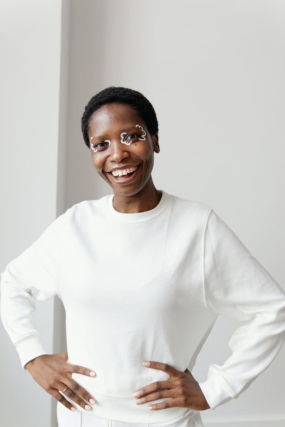 woman in white outfit with fun eyeliner