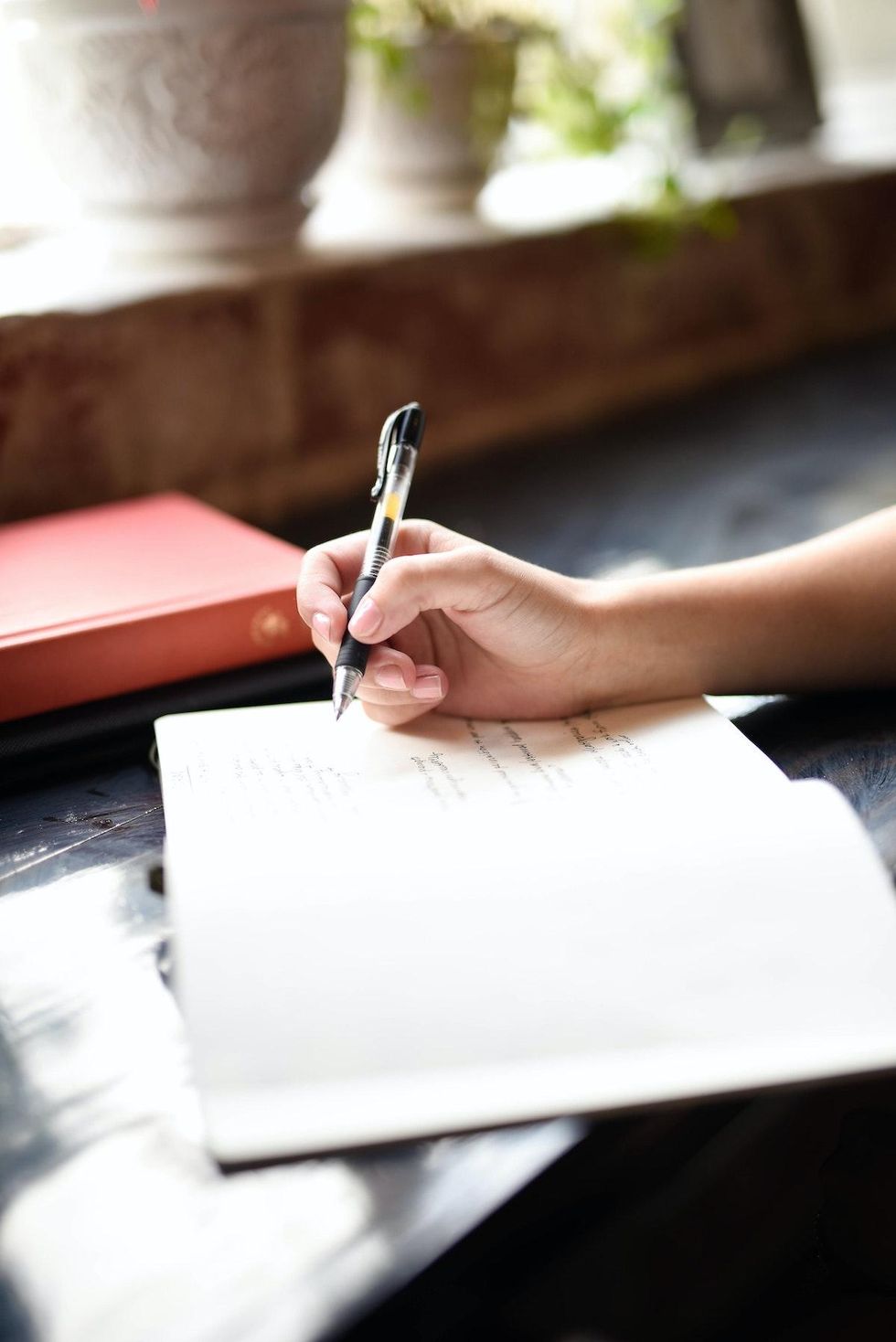 woman journaling by a window