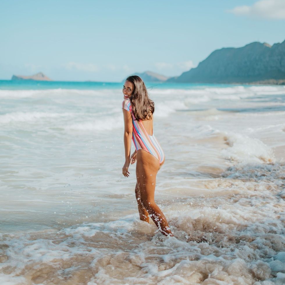 woman playing in the ocean