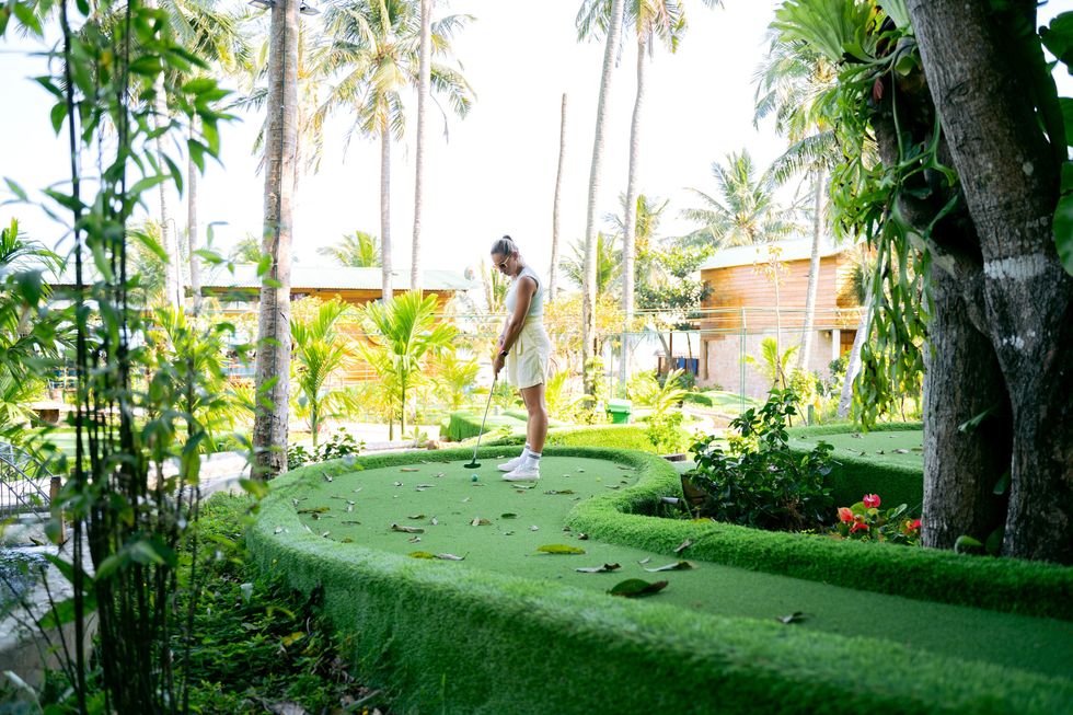 woman playing mini golf