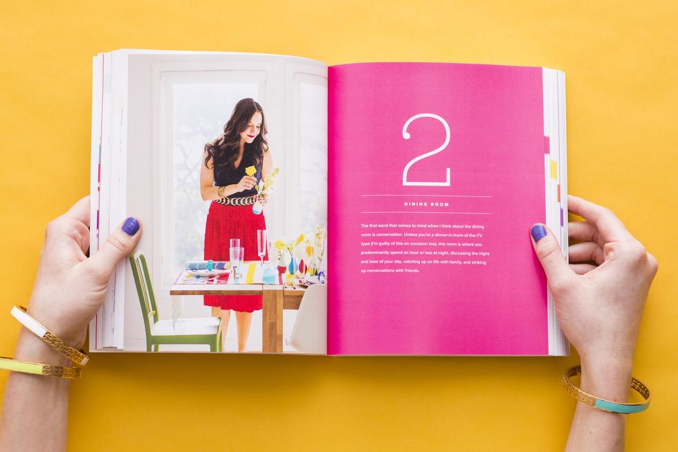 woman reading a book on a colorful background