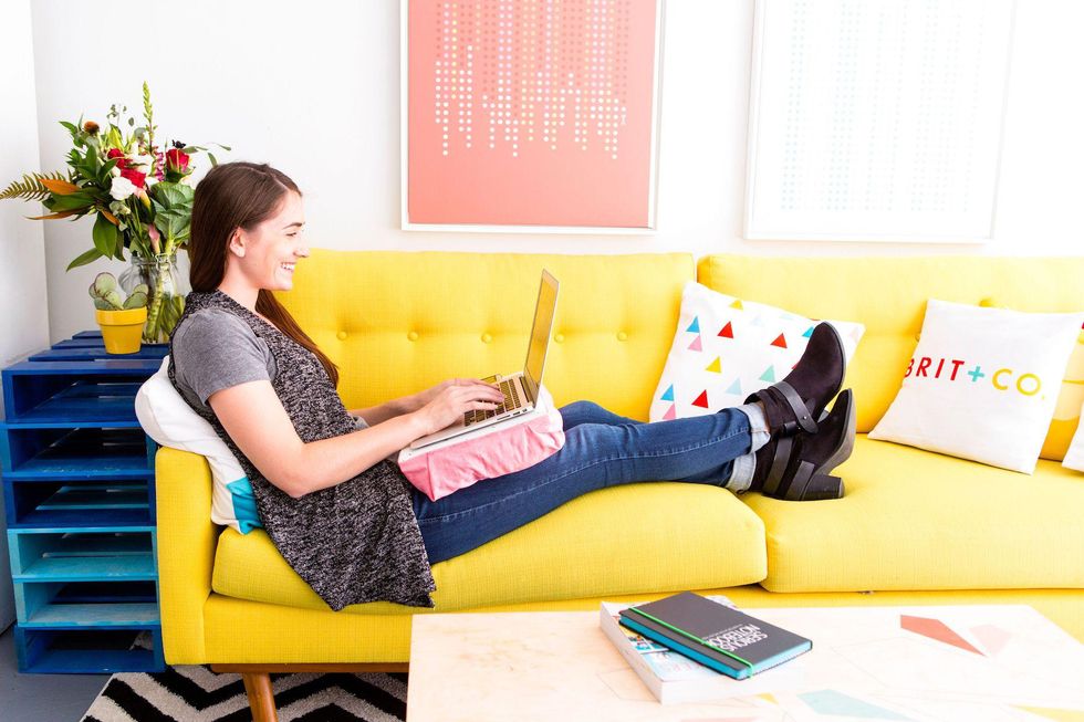 woman relaxing on couch using computer