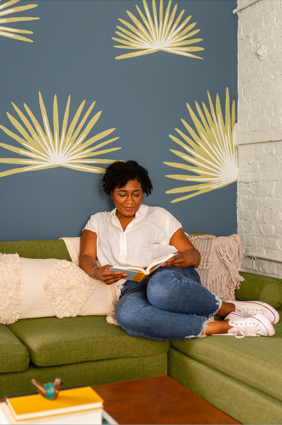 woman sitting on the couch reading a book