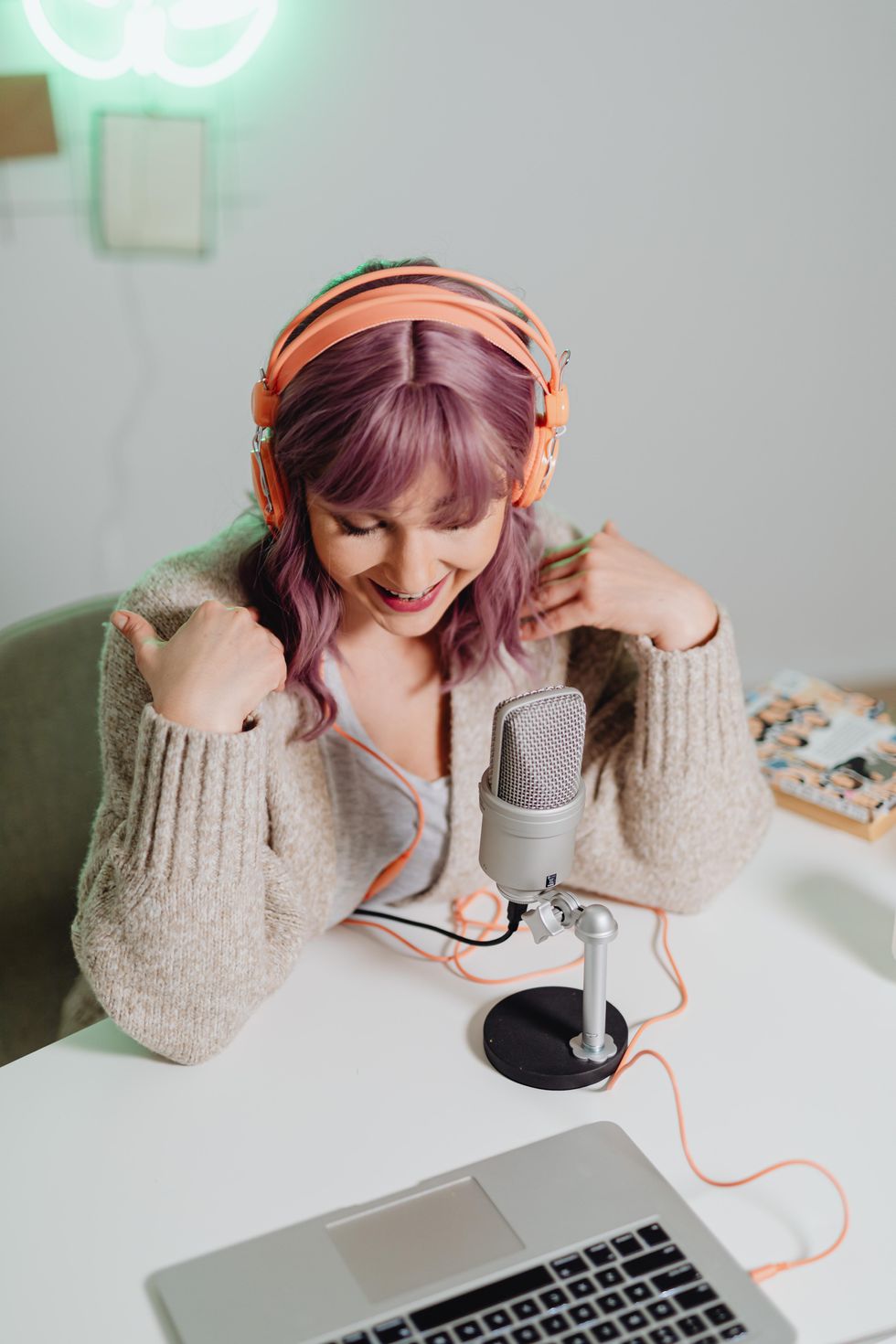 Woman speaking on a podcast into a mic