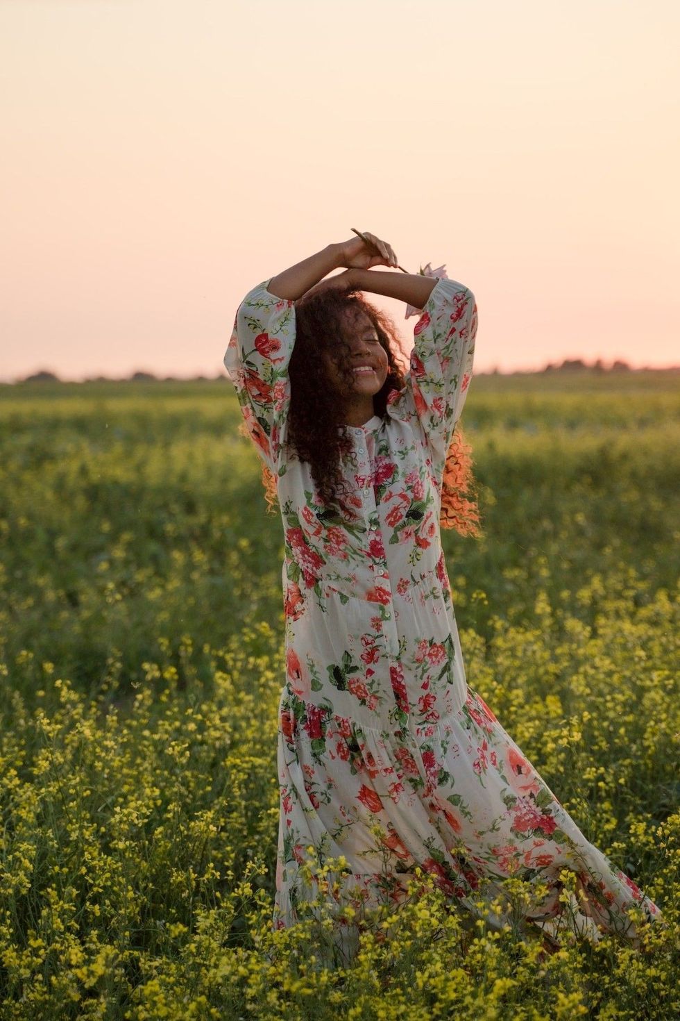 woman standing in a field with flowers